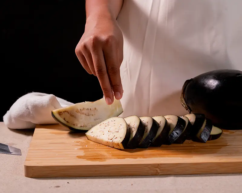Do you need to salt aubergine before cooking? Salted aubergine slices prepared for better browning and texture.