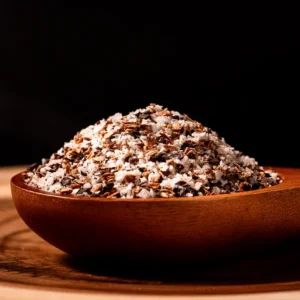 Fermented mushroom salt in a wooden bowl with visible mushroom pieces