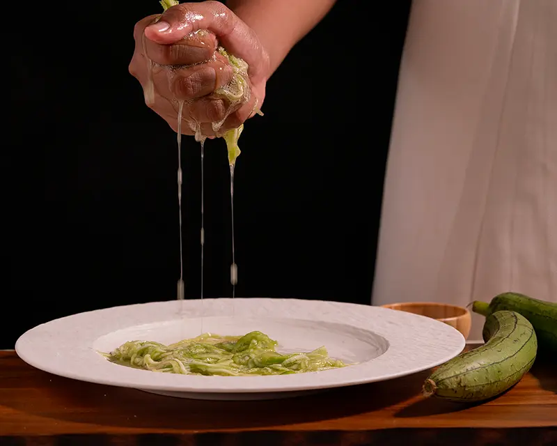 Grated zucchini releasing water after salting, showing how salt moves through food