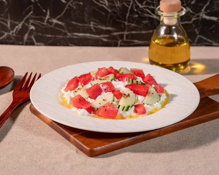 How to salt feta with cucumber, watermelon, olive oil, and finishing salt around the cheese