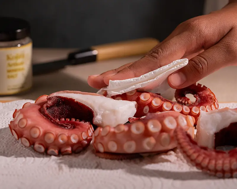How to salt grilled octopus: patting cooked octopus dry before grilling