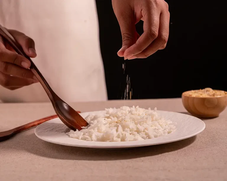 How to salt rice with finishing salt after the grains are fluffed.