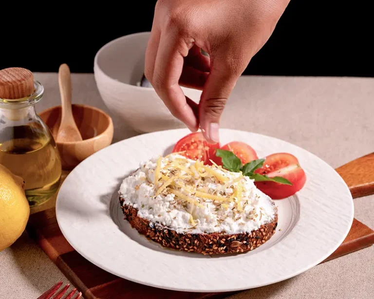 How to salt ricotta with finishing salt, lemon zest, herbs, and tomatoes