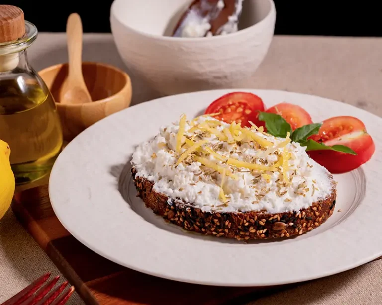 How to salt ricotta with finishing salt, lemon zest, herbs, and tomatoes