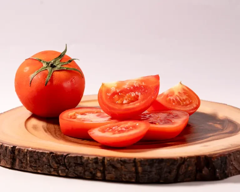 Sliced tomatoes with finishing salt, showing how to salt tomatoes for juice or clean slices