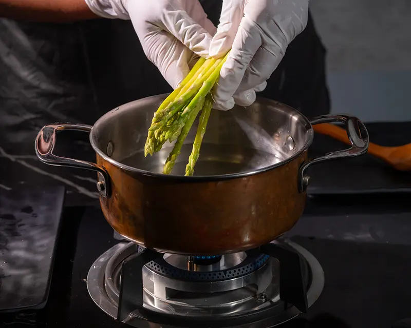 How to season asparagus by adding green asparagus to lightly salted cooking water