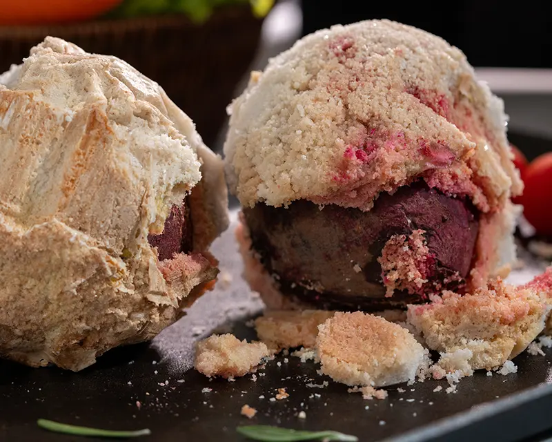 How to season beets using a salt-baked method, with beetroot revealed inside a cracked salt crust.