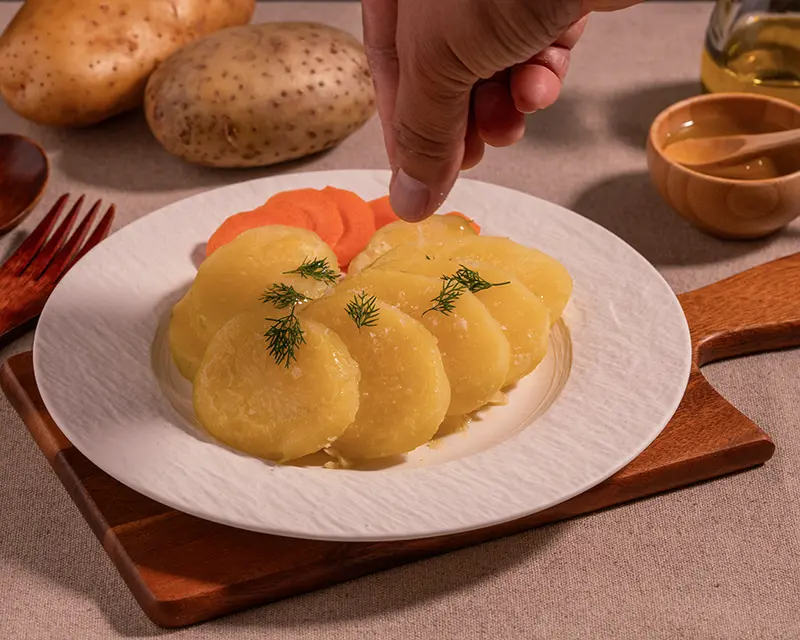 How to season boiled potatoes with finishing salt while they are still warm.
