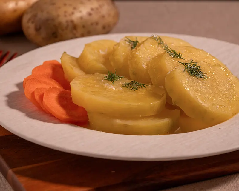 How to season boiled potatoes served warm with dill and finishing salt.