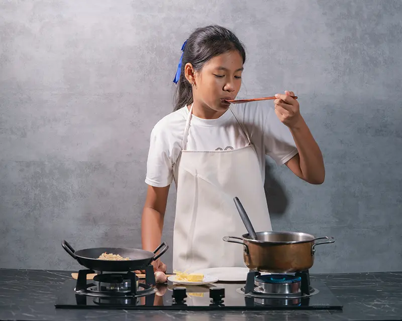 Tasting risotto during cooking while learning how to season risotto