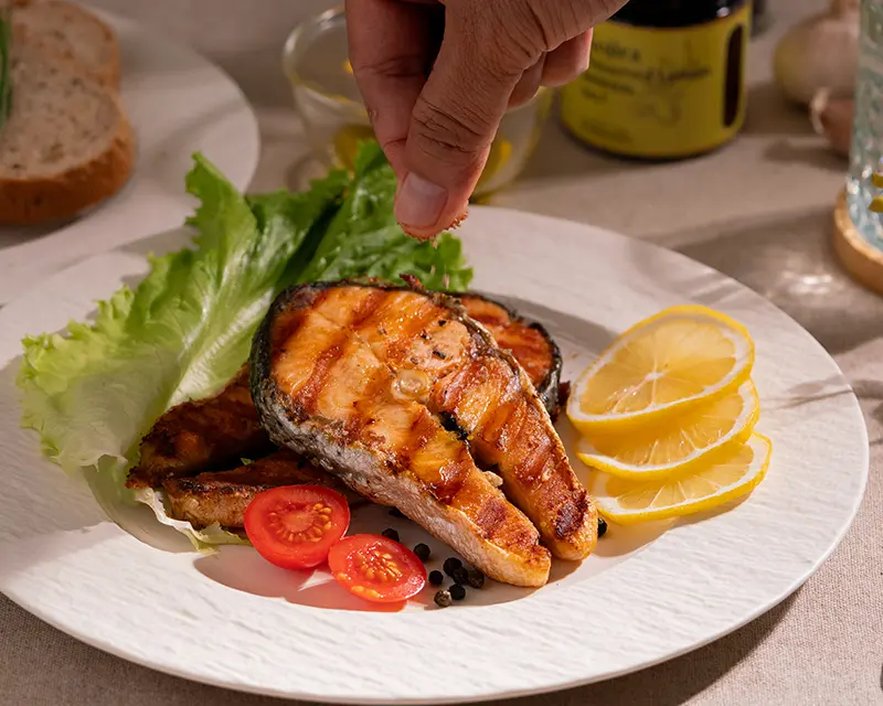 How to season salmon: finishing grilled salmon with Kojira Preserved Lemon Salt just before serving for fresh citrus flavour.