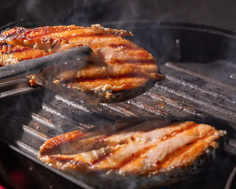 How to season salmon steaks for grilling on a hot ridged pan.