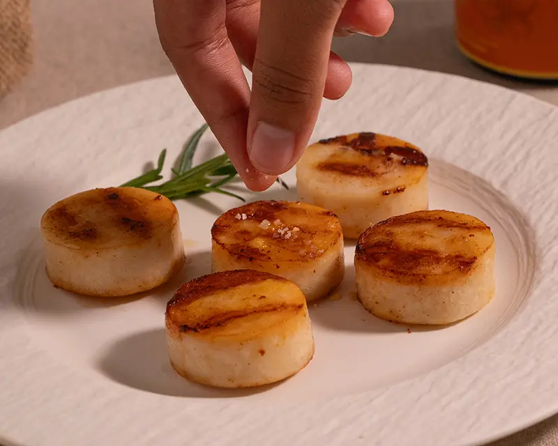 How to season scallops by finishing warm pan-seared scallops with Kojira Persian Saffron Salt.
