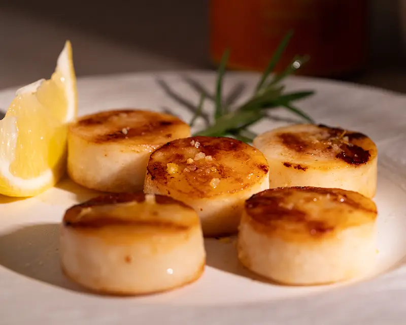 Perfectly seasoned pan-seared scallops with a golden crust and finishing salt.