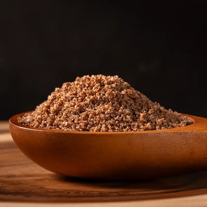 Black garlic salt in a wooden bowl