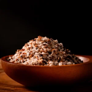 Fermented mushroom salt in a wooden bowl with visible mushroom pieces