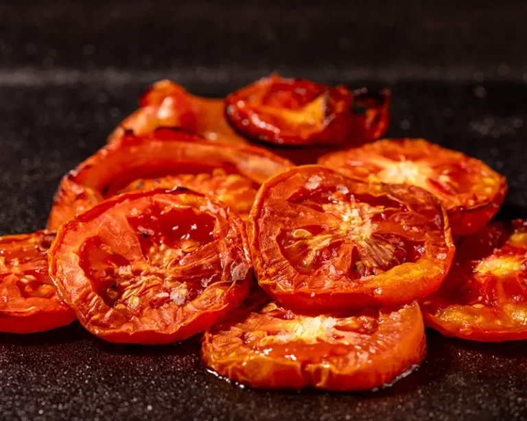Roasted tomatoes with finishing salt, showing how to salt tomatoes after roasting