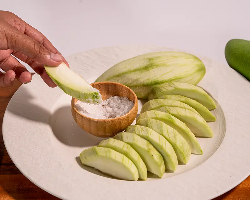 Salt on fruit with green mango dipped in mineral salt