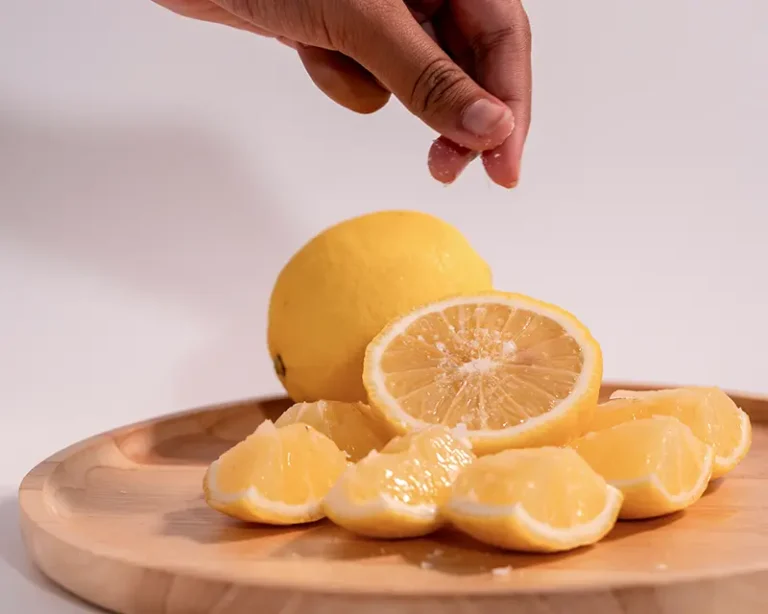 Alt text Salt on fruit shown with sliced lemon, where a tiny pinch softens acidity and brightens citrus.