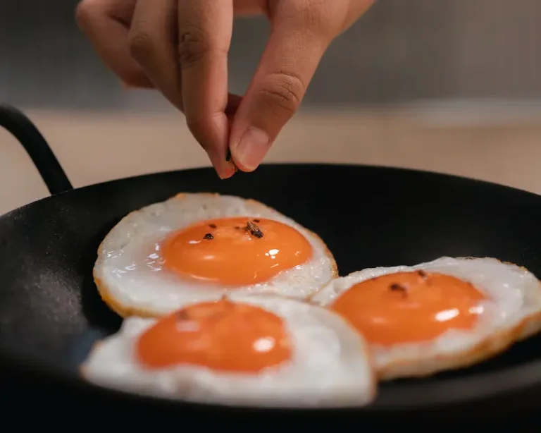 Adding umami salt to fried eggs just before serving