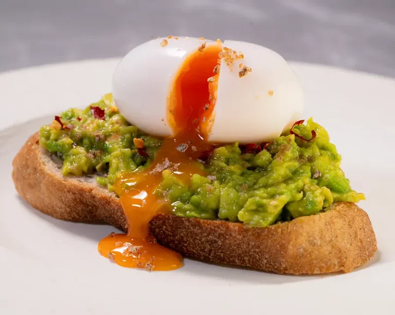 Salt on avocado and soft egg toast, showing why salt makes food taste better by giving rich foods more definition.