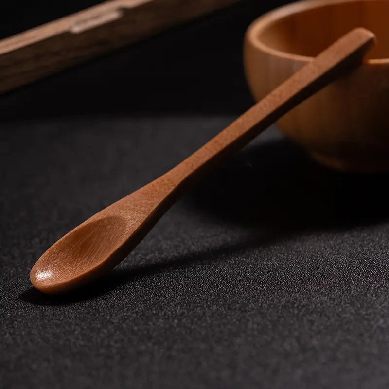 Handmade wooden salt spoon on a dark surface